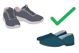 A pair of trainers and a pair of slippers with a big green tick next to them.
