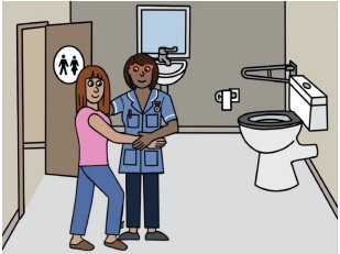A nurse helping a person in a toilet cubicle.