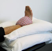 Demonstrates an ice pack on the ankle
