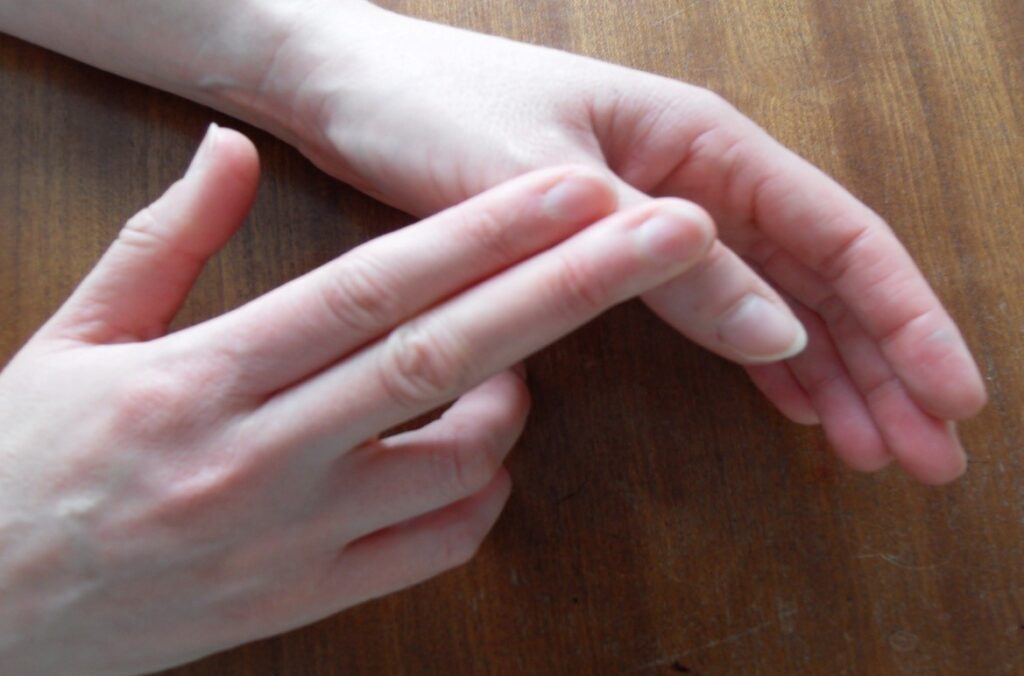 Picture shows hand exercises, pushing the thumb upwards.
