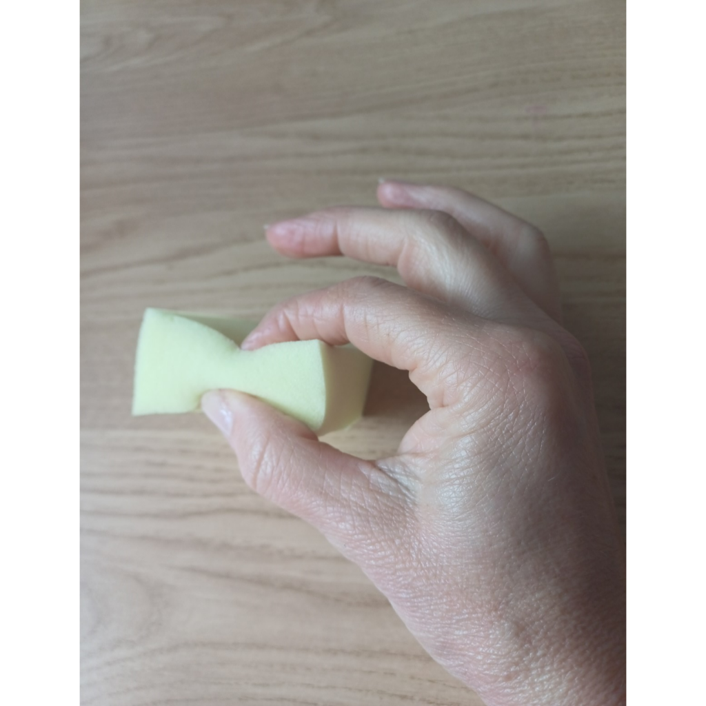 Hand squeezing sponge or putty between thumb and each fingertip