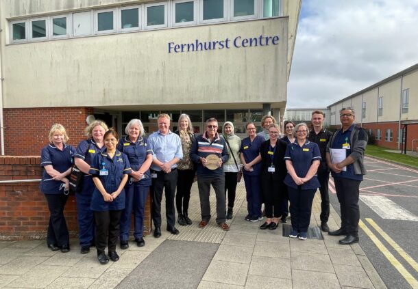 Fernhurst centre staff with former patient receiving award.