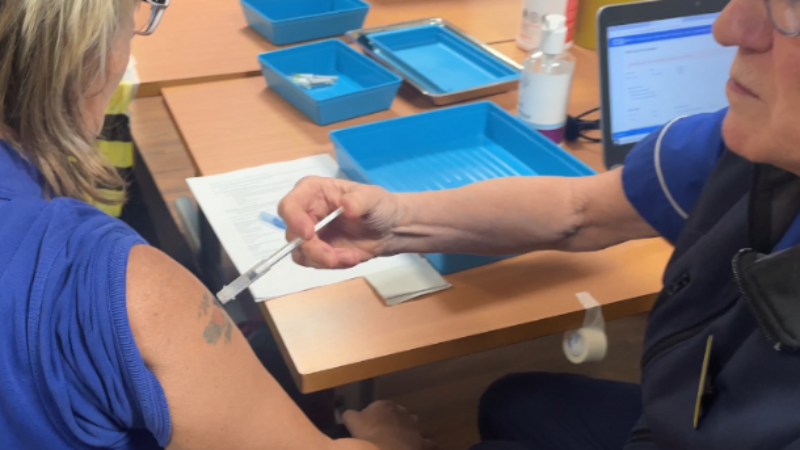 Peer vaccination, colleague vaccinating another colleague