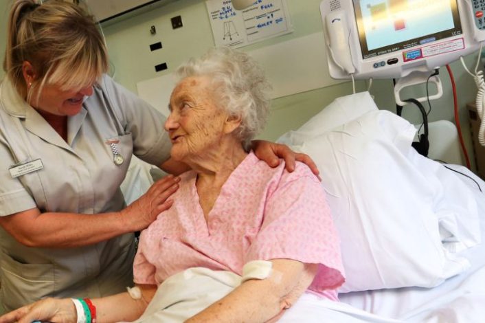Nurse caring for patient on ward