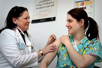 Photograph of a health professional immunising a member of the public.